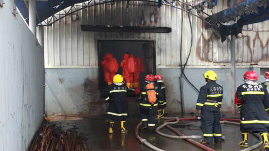 Firefighters do rescue works after a fire at a poultry slaughterhouse in Dehui, Jilin Province of China.